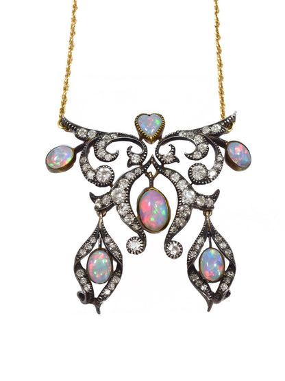 Antique 14K topped silver lavaliere necklace with opal and diamond pendant on a white background